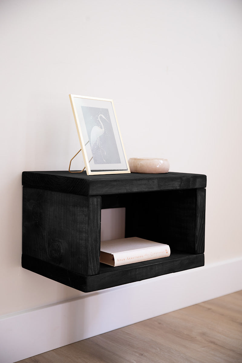 Zwart houten nachtkastje van Baan Woods dat lijkt te zweven 